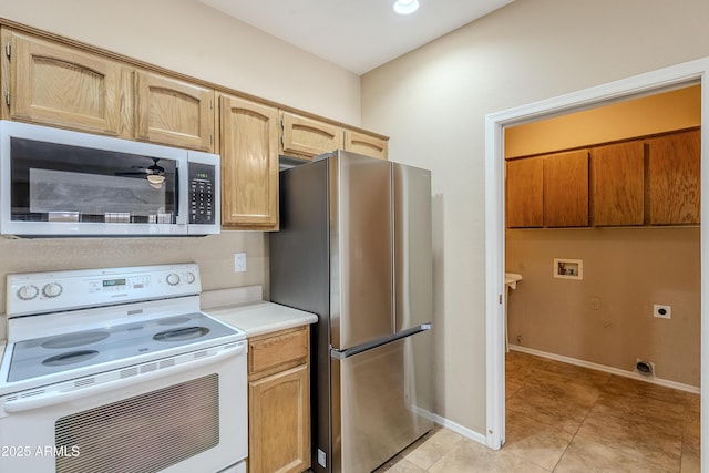 kitchen featuring stainless steel appliances, ceiling fan, and light tile patterned flooring