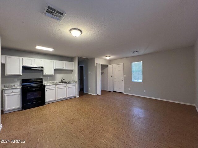 kitchen featuring black gas stove, white cabinetry, a textured ceiling, wood-type flooring, and sink