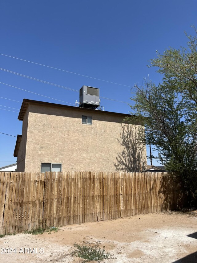 view of side of property featuring central AC