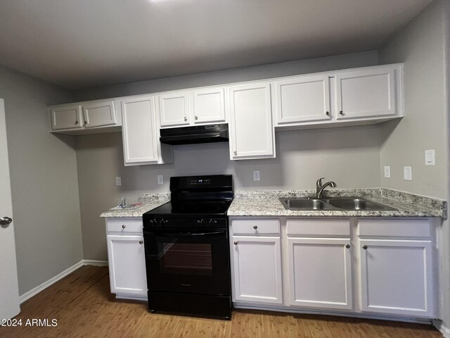 kitchen with sink, light stone countertops, electric range, white cabinets, and light hardwood / wood-style floors