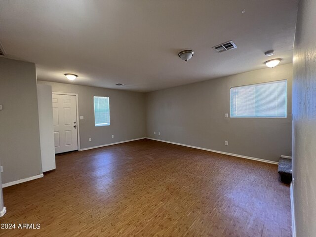 unfurnished room with hardwood / wood-style flooring and a wealth of natural light