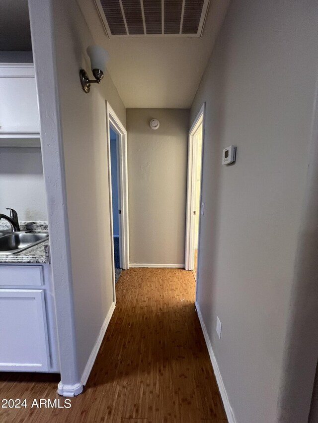 hall featuring dark wood-type flooring and sink