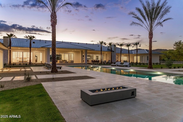 exterior space featuring a patio area and a fire pit