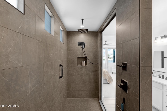 bathroom featuring vanity, ceiling fan, and a shower stall
