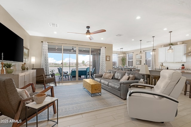 living room with visible vents, ceiling fan, and recessed lighting