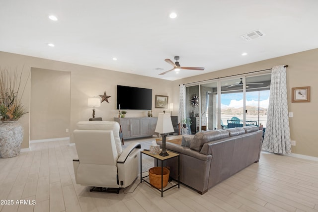 living room with a ceiling fan, baseboards, visible vents, light wood-style floors, and recessed lighting