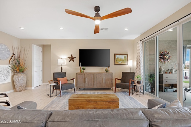 living room with light wood-style flooring, visible vents, baseboards, recessed lighting, and a ceiling fan