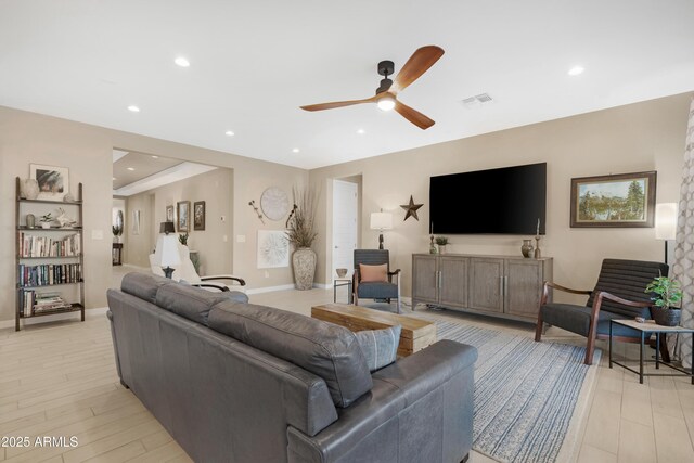 living area featuring light wood-style flooring, baseboards, visible vents, ceiling fan, and recessed lighting