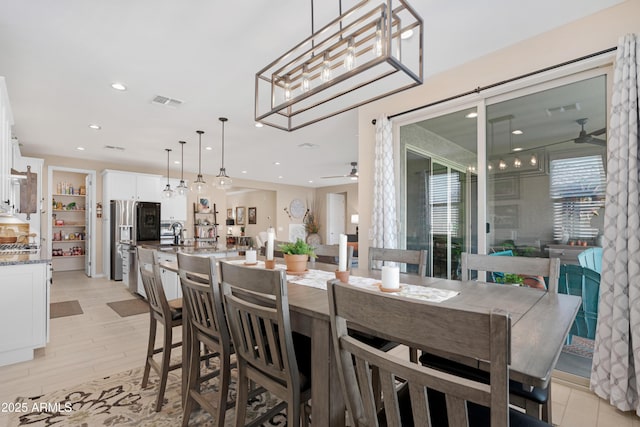 dining space featuring a ceiling fan, recessed lighting, and light wood-type flooring