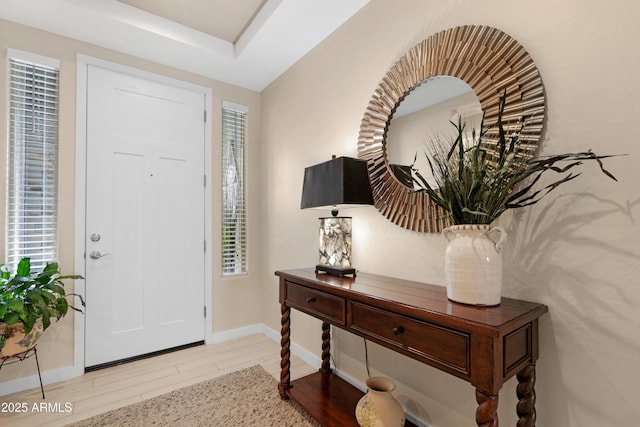 foyer with baseboards and wood finished floors