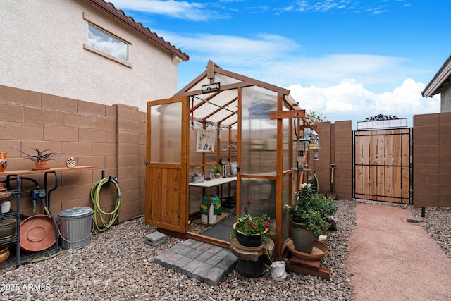 exterior space with a fenced backyard, an outdoor structure, and an exterior structure