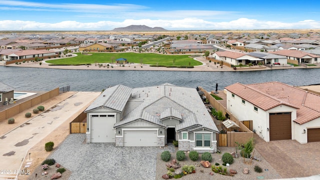 drone / aerial view with a residential view and a water view