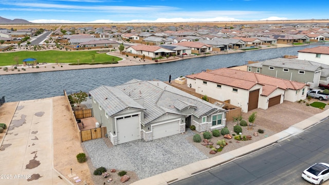drone / aerial view with a residential view and a water view
