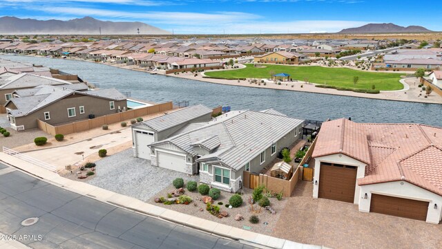 birds eye view of property with a residential view and a water and mountain view