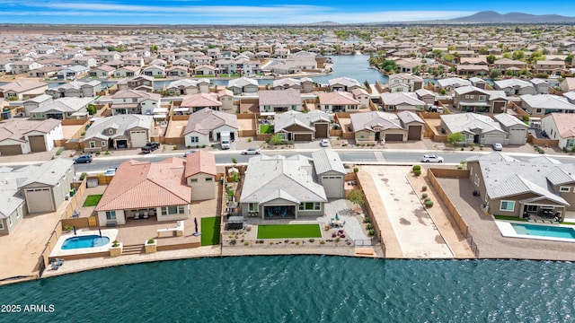 birds eye view of property featuring a residential view and a water view