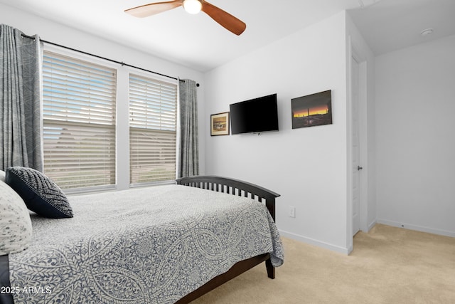 bedroom featuring baseboards, ceiling fan, and carpet