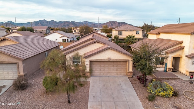 view of front facade featuring a garage and a mountain view