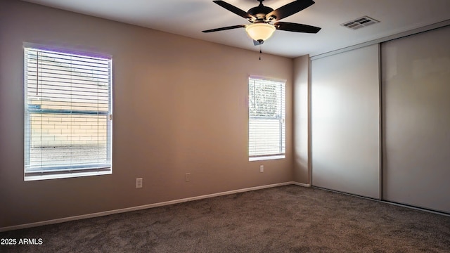 carpeted empty room featuring ceiling fan