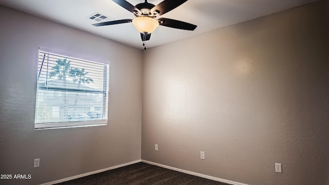 carpeted spare room featuring ceiling fan