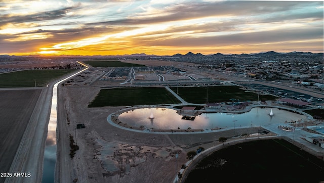 aerial view at dusk featuring a mountain view