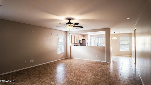 unfurnished room featuring ceiling fan