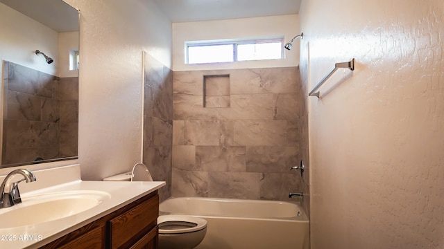 full bathroom with tiled shower / bath, vanity, and toilet