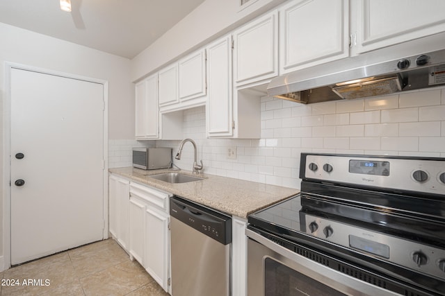 kitchen featuring stainless steel appliances, sink, backsplash, and white cabinets