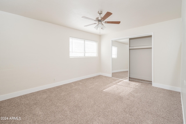 unfurnished bedroom with a closet, ceiling fan, and light carpet