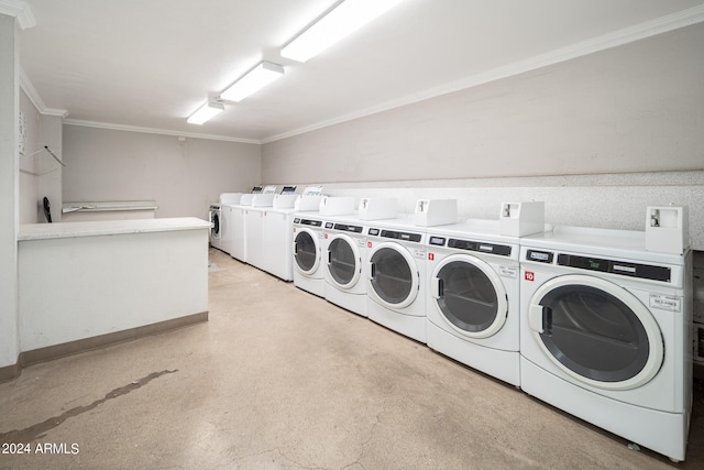 clothes washing area featuring ornamental molding and washer and dryer