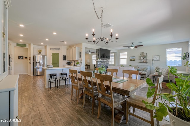 dining space with light wood-type flooring, visible vents, a healthy amount of sunlight, and ceiling fan