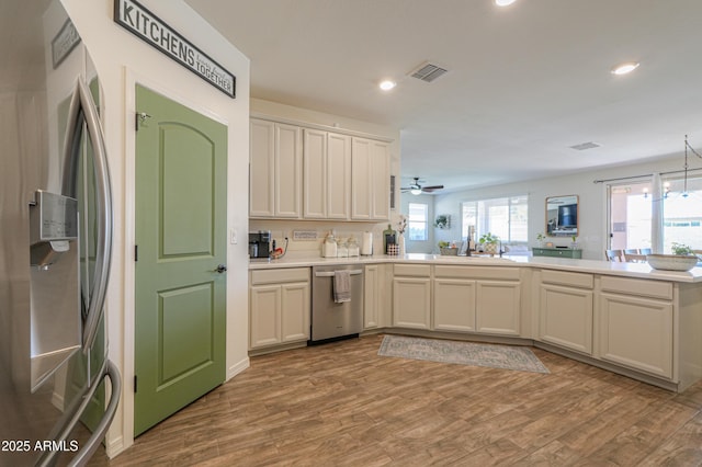 kitchen featuring visible vents, appliances with stainless steel finishes, wood finished floors, and light countertops