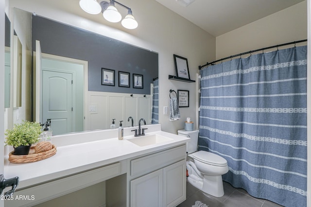 bathroom featuring tile patterned floors, toilet, and vanity