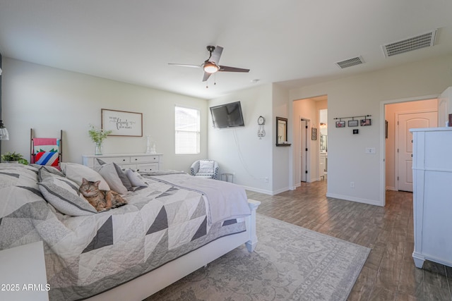 bedroom with visible vents, ceiling fan, baseboards, and wood finished floors