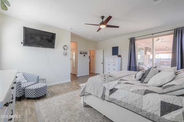 bedroom featuring a ceiling fan, baseboards, and light wood finished floors