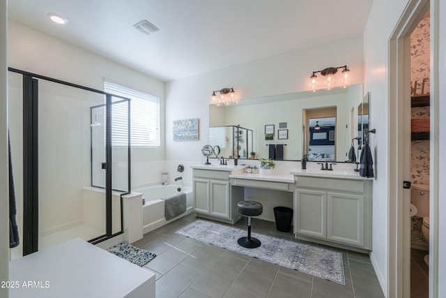 bathroom with visible vents, ensuite bathroom, a shower stall, a bath, and vanity