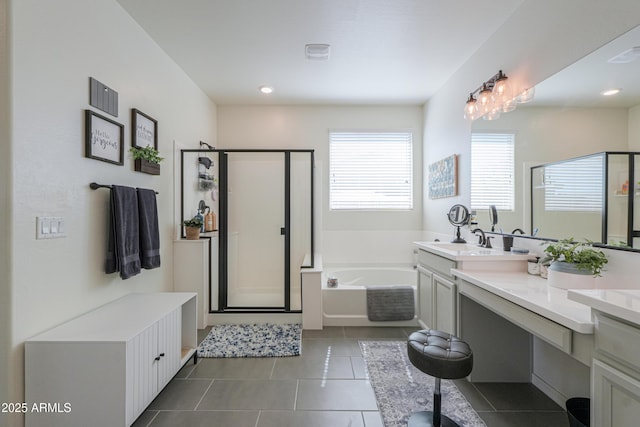 bathroom featuring tile patterned floors, double vanity, a shower stall, and a sink