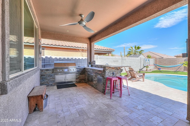 view of patio / terrace with a ceiling fan, a fenced in pool, an outdoor kitchen, a fenced backyard, and outdoor dry bar