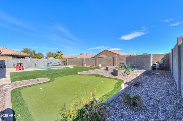 view of yard featuring a patio, a fenced in pool, and a fenced backyard