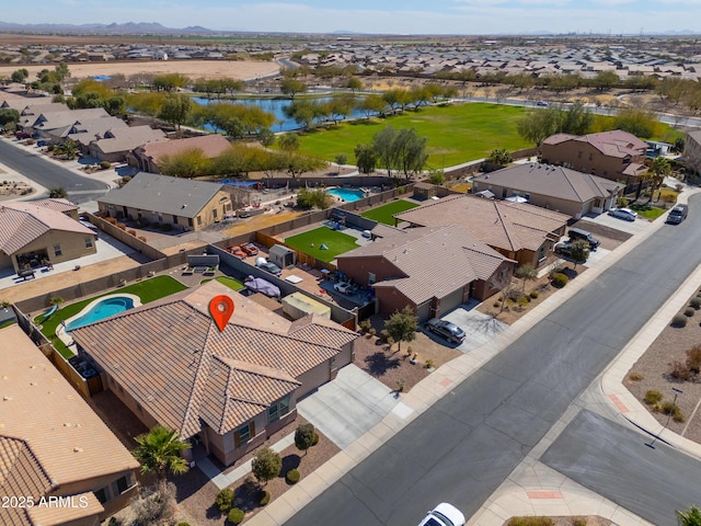 drone / aerial view featuring a residential view and a water view