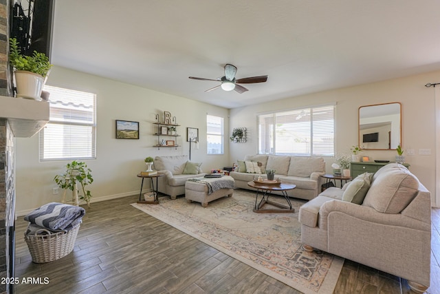 living area with ceiling fan, baseboards, and wood finished floors