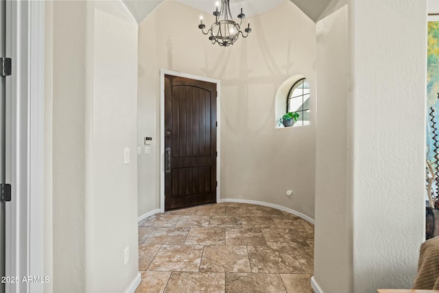 891 W Palo Brea Dr, Litchfield Park, AZ 85340 - foyer featuring stone finish flooring, baseboards, and a chandelier