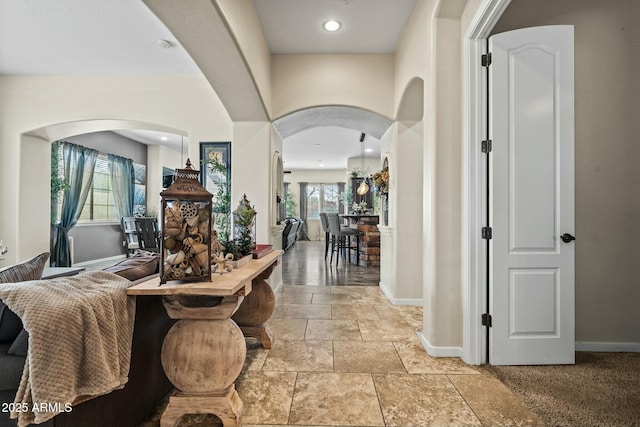 891 W Palo Brea Dr, Litchfield Park, AZ 85340 - foyer featuring baseboards, stone finish floor, recessed lighting, and arched walkways