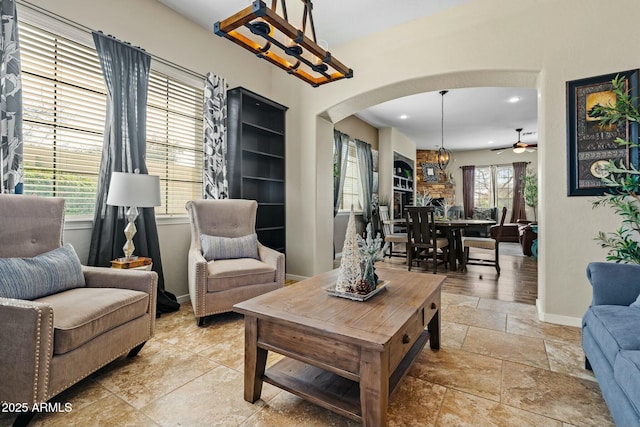 891 W Palo Brea Dr, Litchfield Park, AZ 85340 - living room featuring recessed lighting, a ceiling fan, baseboards, arched walkways, and stone tile floors