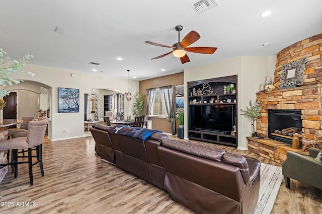 891 W Palo Brea Dr, Litchfield Park, AZ 85340 - living room featuring visible vents, a fireplace, and light wood-type flooring