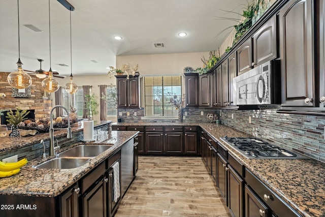 891 W Palo Brea Dr, Litchfield Park, AZ 85340 - kitchen with dark brown cabinets, stainless steel appliances, visible vents, a sink, and pendant lighting