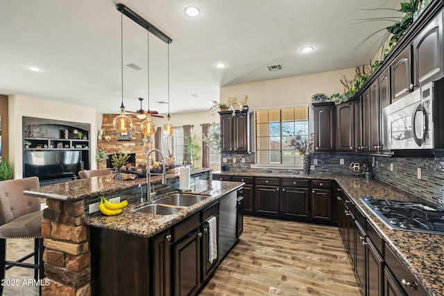 891 W Palo Brea Dr, Litchfield Park, AZ 85340 - kitchen with a breakfast bar area, appliances with stainless steel finishes, visible vents, an island with sink, and a sink