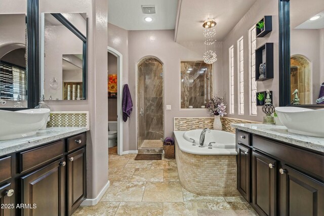 891 W Palo Brea Dr, Litchfield Park, AZ 85340 - full bathroom with a sink, visible vents, a bath, and two vanities