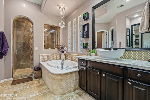 891 W Palo Brea Dr, Litchfield Park, AZ 85340 - full bath featuring a stall shower, vanity, visible vents, a bath, and stone tile flooring