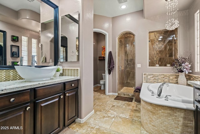 891 W Palo Brea Dr, Litchfield Park, AZ 85340 - bathroom with vanity, visible vents, a garden tub, and baseboards