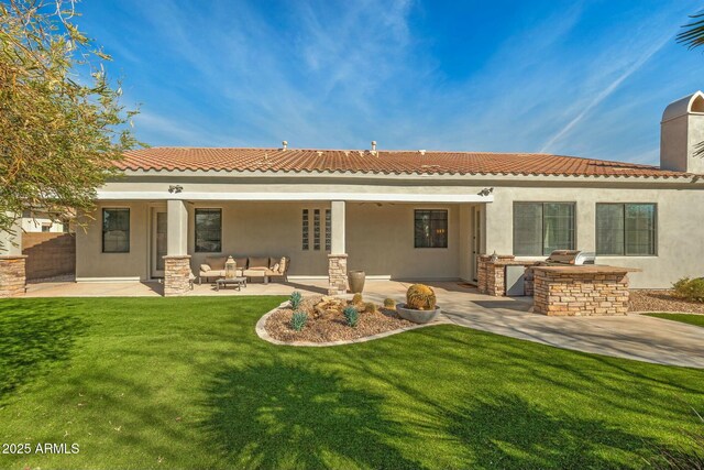 891 W Palo Brea Dr, Litchfield Park, AZ 85340 - rear view of property with stucco siding, an outdoor kitchen, a patio area, and a lawn